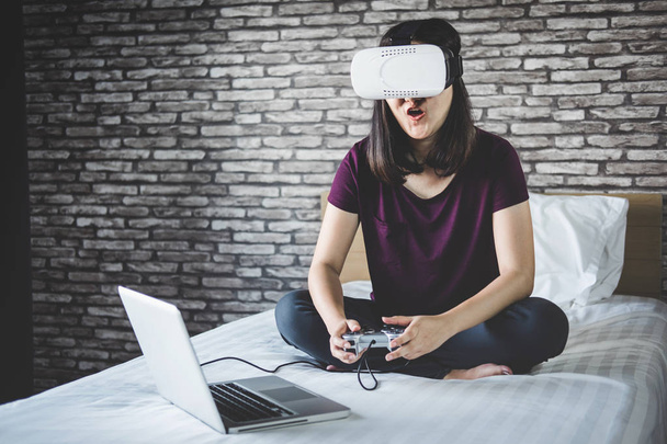 Young woman have fun in virtual reality headset or 3d glasses pl - Photo, image