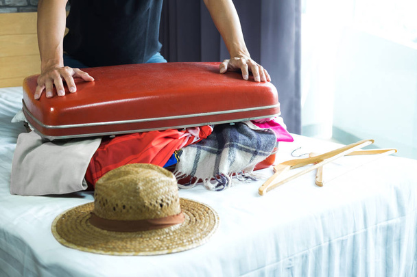 Travel and vacation concept, happiness young man packing a lot o - Foto, Imagem