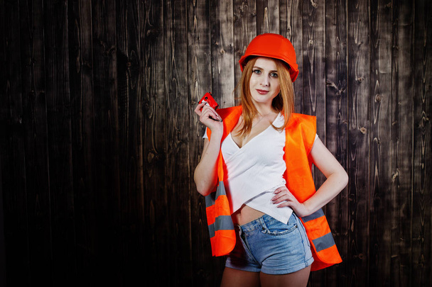 Engineer woman in orange protect helmet and building jacket agai - Φωτογραφία, εικόνα