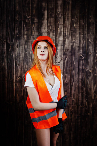 Engineer woman in orange protect helmet and building jacket agai - Zdjęcie, obraz