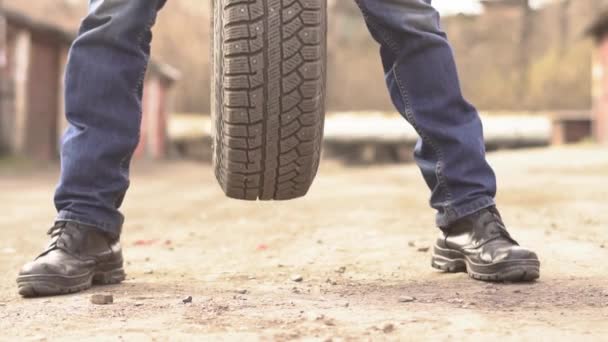 Mécanicien tenant un pneu de voiture au garage
 - Séquence, vidéo