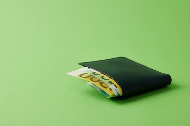 close-up shot of wallet with euro banknotes on green - Zdjęcie, obraz