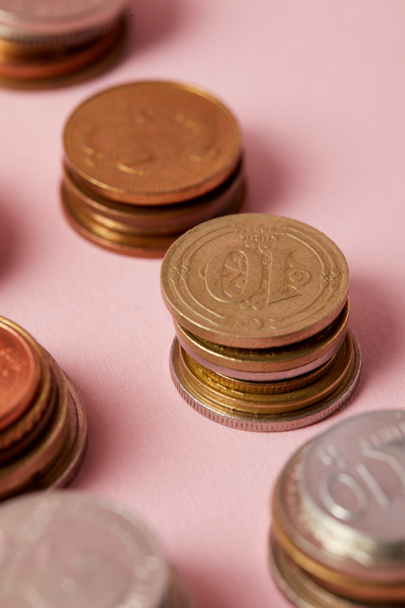 close-up shot of stacks of different coins on pink - Foto, Imagem