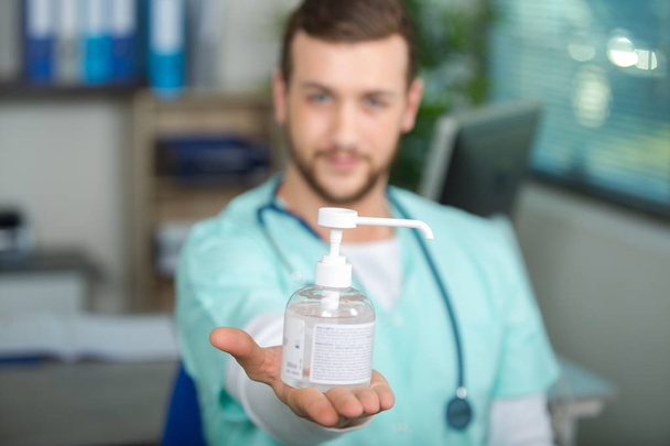doctor holding a bottle of disinfecting liquid - Valokuva, kuva