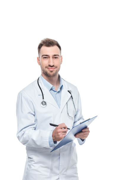 young male doctor with stethoscope and diagnosis isolated on white background - Photo, image