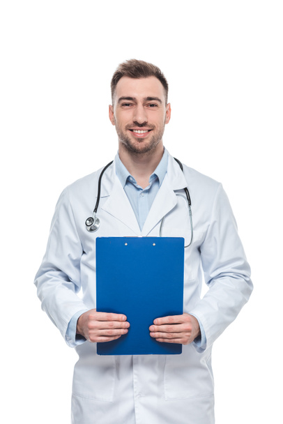 smiling male doctor with stethoscope and clipboard isolated on white background - Foto, Imagen