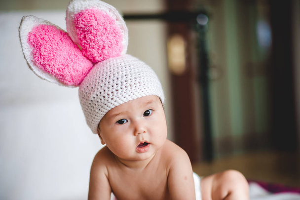 Portrait of asian baby in hat with rabbit ears on white background - Fotografie, Obrázek