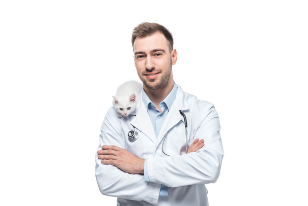 smiling male veterinarian with kitten isolated on white background - 写真・画像