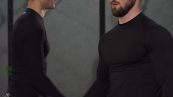 Обрізаний знімок бородатого м'язистого чоловіка, що піднімає ваги в спортзалі
 - Кадри, відео