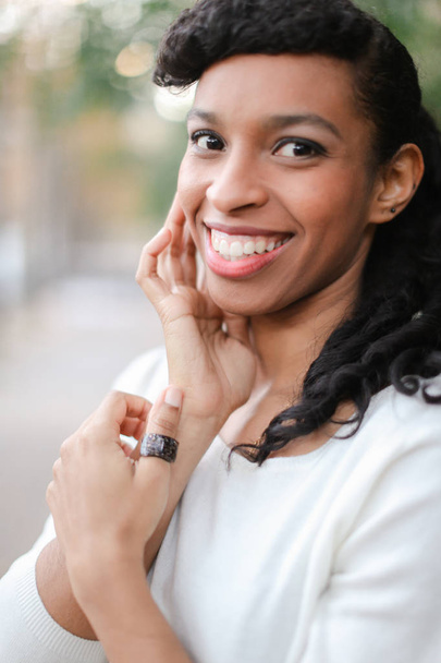 Portret ładne afro american osoby płci żeńskiej z koński ogon i pierścień uśmiechający się z białe zęby. - Zdjęcie, obraz