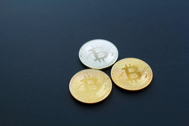 Picture of three gold bitcoin over black background. Digital mon - Foto, Imagem