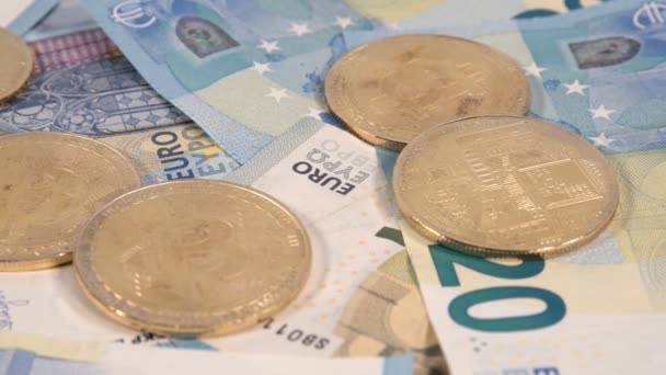 Virtual cryptocurrency money Bitcoin golden coins on European Union EU Euro 5, 10 and 20 banknotes 4k slider. - Záběry, video