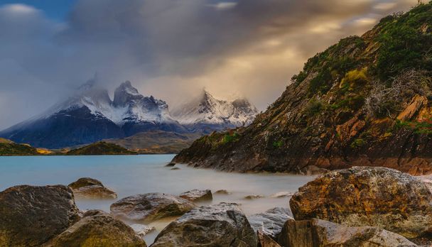 View of the mountains and the lake during the sunrise of Torres del Paine National Park. Autumn in Patagonia, the Chilean side - Photo, Image