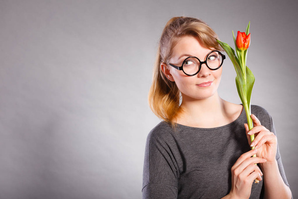 Girl with tulip full of hope dreaming. - Фото, зображення