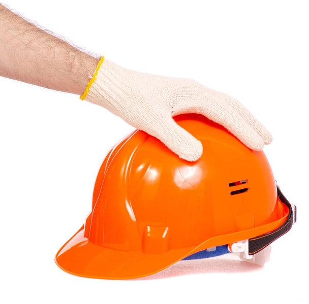 Orange man's helmet man's hand in a glove - Fotoğraf, Görsel