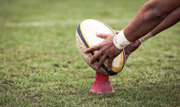 rugby player preparing to kick the oval ball during game - Photo, Image