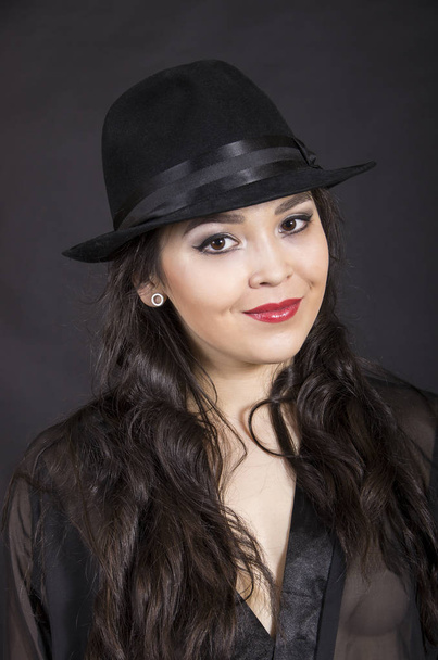Beautiful young girl in black tunic, black gloves and black hat. - Φωτογραφία, εικόνα