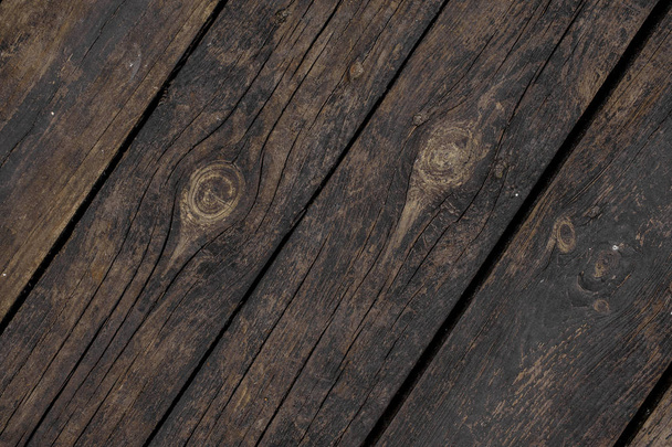 Close up texture background of old dark wooden boards obliquely arranged in a floor - Foto, imagen