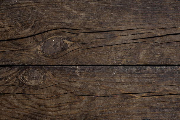 Macrophotography texture background of two horizontally arranged old dark wooden boards - Foto, afbeelding