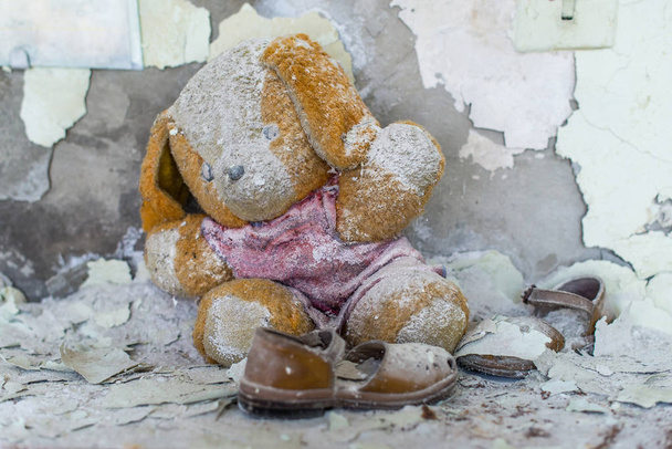 Abandoned kindergarten in Chernobyl Exclusion Zone. Lost toys, A broken doll. Atmosphere of fear and loneliness. Ukraine, ghost town Pripyat. - Photo, Image