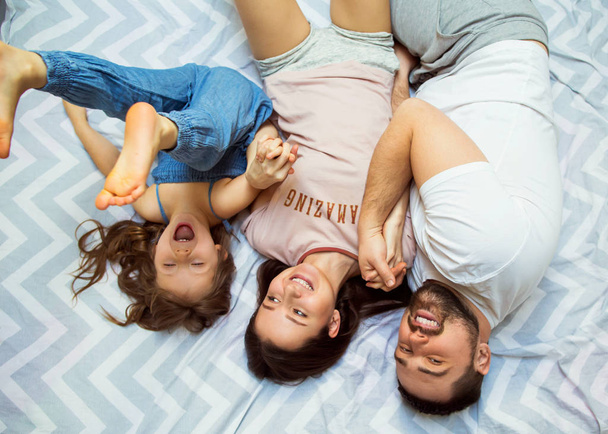 family with daughter having fun at home, the concept of a happy family. - 写真・画像