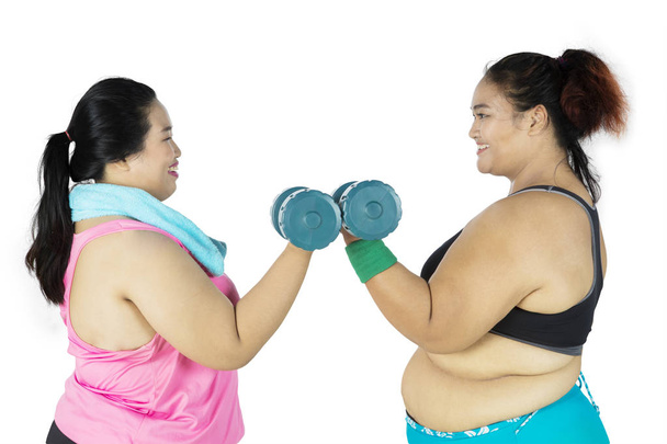 Two fat women doing a workout together - Zdjęcie, obraz