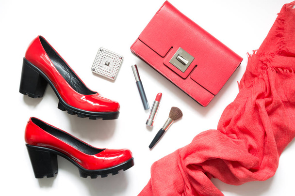 Collection of red women's accessories for new look, cocktail dress, special event or holiday. Red shoes, clutch, shawl and cosmetics. Flat lay. Top view. - 写真・画像