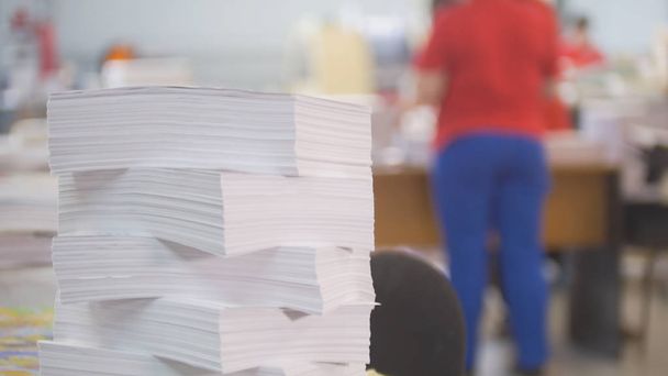Paper stack in front of worker in the typography - Photo, Image