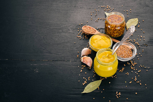 A set of mustard and spice. On a wooden background. Top view. Copy space for your text. - Foto, Bild