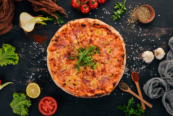 Caesar Pizza. Chicken fillet, bacon, mozzarella. Top view. On a wooden background. Copy space. - Foto, imagen