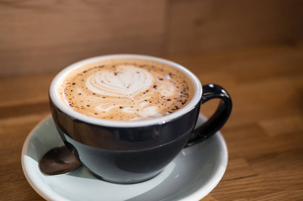 A cup of coffee with latte art - Φωτογραφία, εικόνα