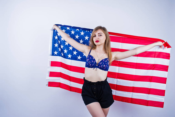 Cute girl in bra and shorts with american usa flag isolated on w - Fotó, kép