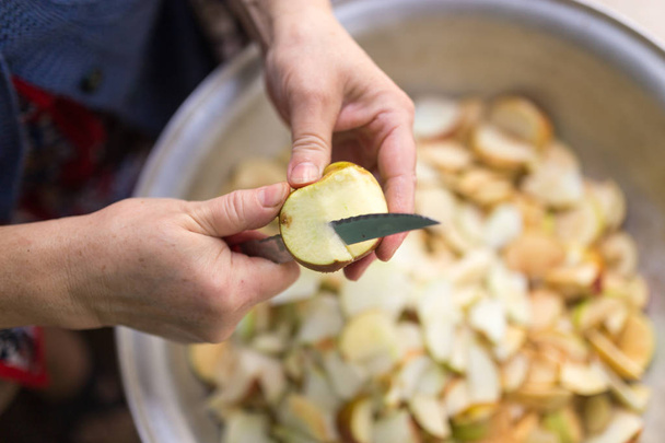cutting an apple with a knife - 写真・画像