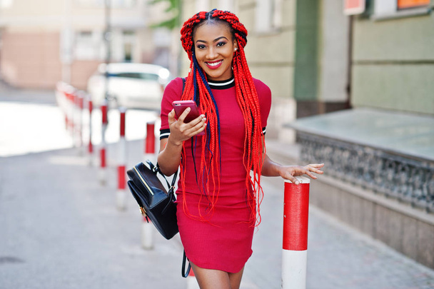 Cute and slim african american girl in red dress with dreadlocks - Foto, Imagen