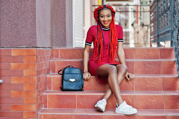 Cute and slim african american girl in red dress with dreadlocks - Foto, immagini