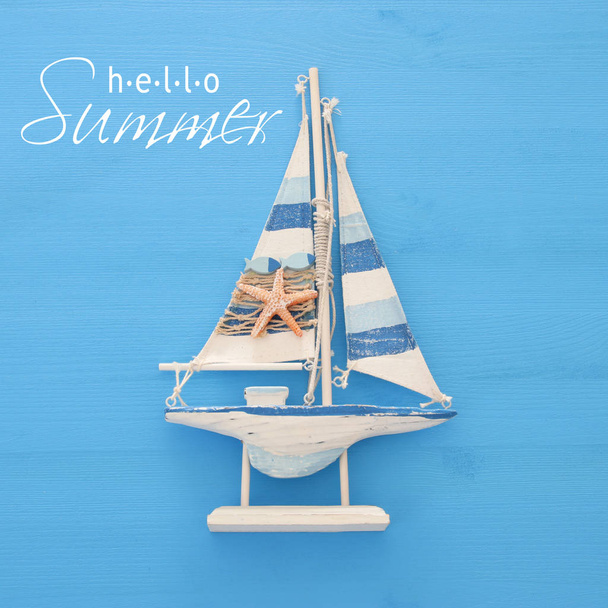 vacation and summer image with boat over blue wooden background. - Fotoğraf, Görsel