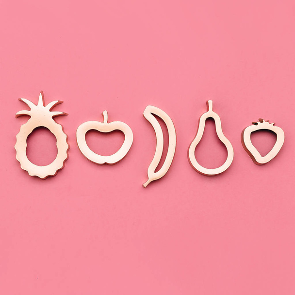 Gold set of fruit forms on pink - Φωτογραφία, εικόνα