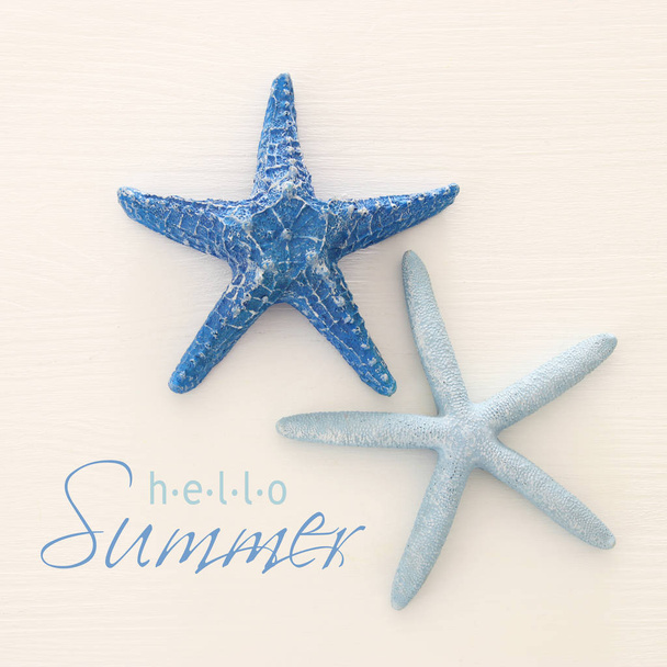 vacation and summer image with starfish over wooden background. - Valokuva, kuva