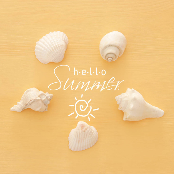 vacation and summer image with seashells over yellow wooden background. - Φωτογραφία, εικόνα