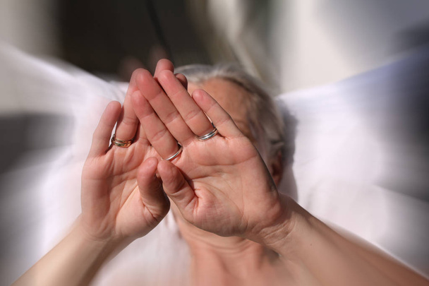 Close up portrait of woman covering her face with hands in blurred background. Sex concept. Focus on woman hand. Rape and sexual abuse. Stop violence against women, concept photo of Sexual assault - Φωτογραφία, εικόνα