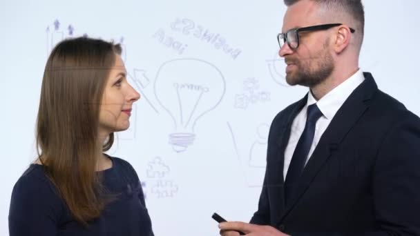 Hombre y mujer se dan la mano y discuten la estrategia de negocio para el éxito en una moderna oficina de vidrio
 - Metraje, vídeo