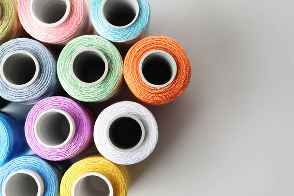 Color sewing threads on white background, top view - Photo, image