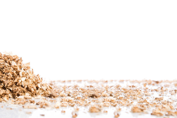 Oak wood shavings on white background, shadows and reflections, wood waste, space for text - Photo, image