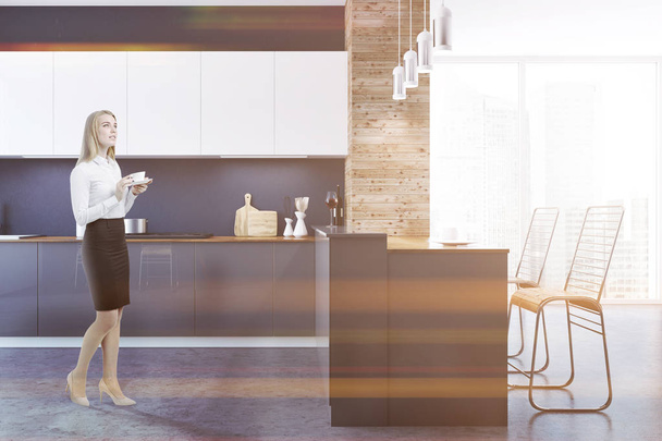Loft black and wooden wall kitchen interior with a concrete floor, white and gray countertops and original ceiling lamps. A blonde woman. 3d rendering mock up toned image - Zdjęcie, obraz