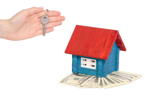 Wooden small color house in hands key with dollars money - Photo, Image
