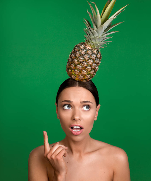 Puzzled lady with pineapple on the top - Photo, image