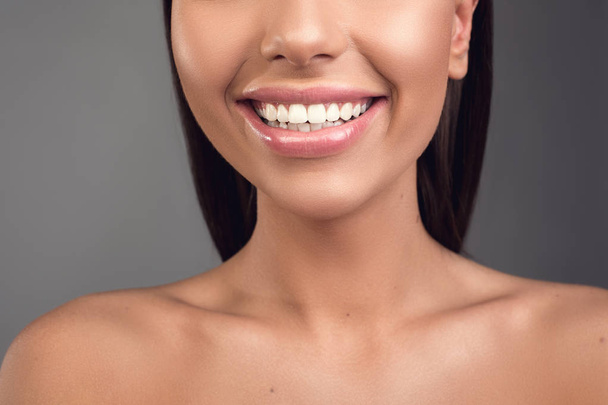 Cared female lips stretched in smile - Φωτογραφία, εικόνα