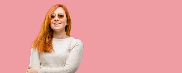 Beautiful young redhead woman confident and happy with a big natural smile laughing - Фото, зображення