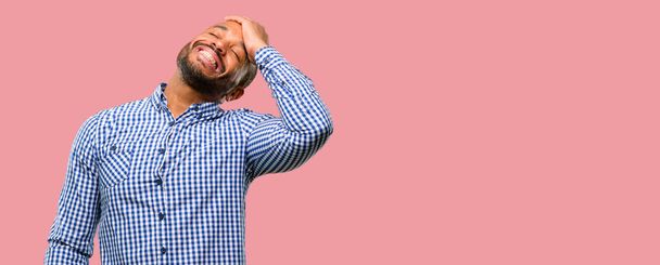 African american man with beard confident and happy with a big natural smile laughing - Foto, imagen