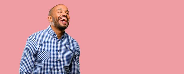 African american man with beard happy and surprised cheering expressing wow gesture - Фото, изображение